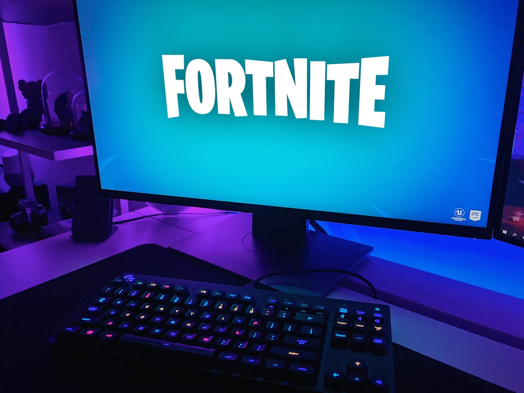 A cozy gaming setup featuring a console, controller, and a large screen, with ambient lighting and comfortable seating.