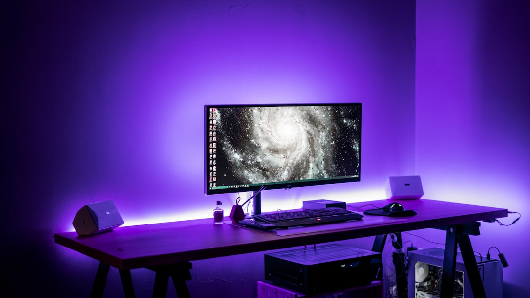 A cozy home gaming station featuring a computer, gaming chair, and accessories, designed for comfort and functionality.