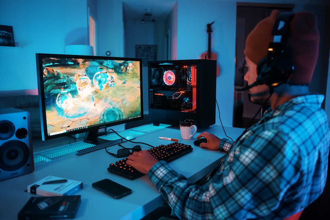 A gamer intensely focused on their screen, surrounded by a well-organized gaming setup with ambient lighting.