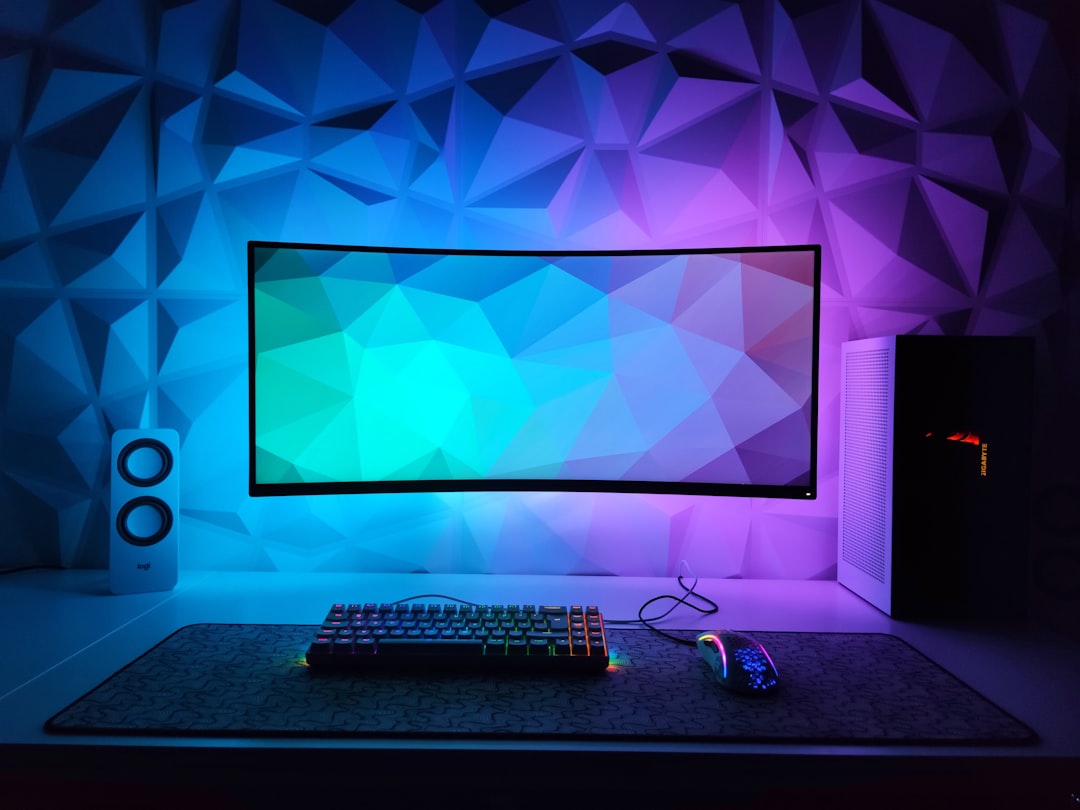 A simple gaming setup with a computer, microphone, and headset in a cozy room environment.