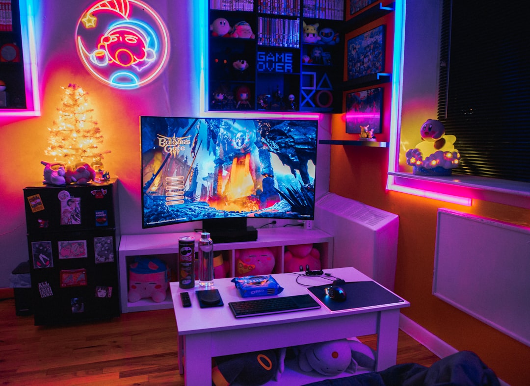 A cozy gaming room featuring ergonomic furniture, a large monitor, and ambient lighting, creating an inviting atmosphere for gamers.